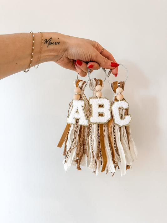 initial bag tassel neutral